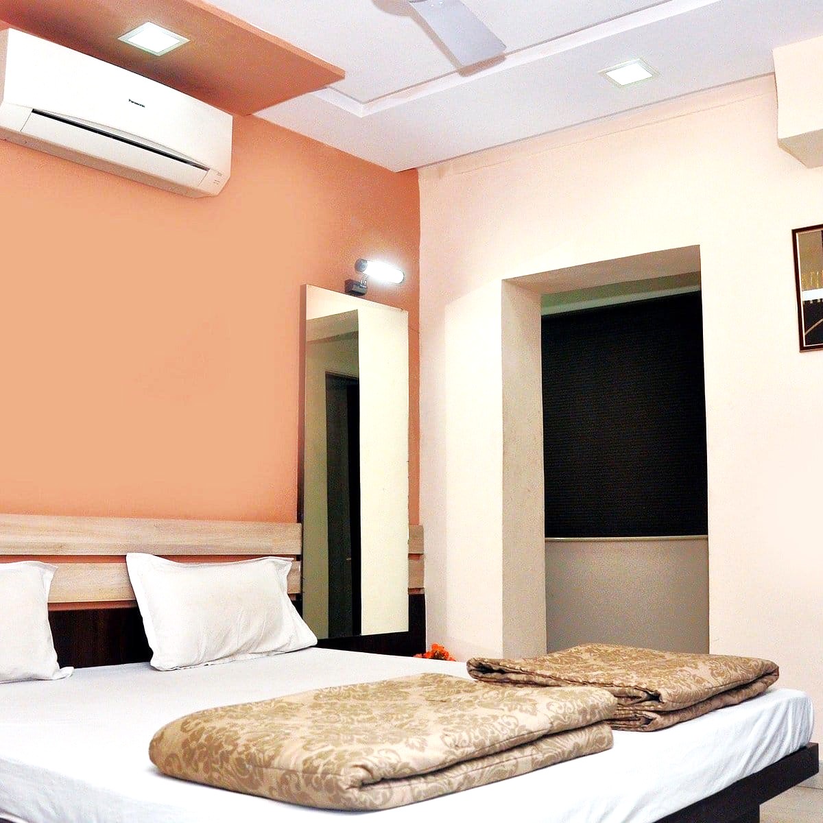 Comfortable double bed AC room with modern amenities at Shree Paras White Hotel