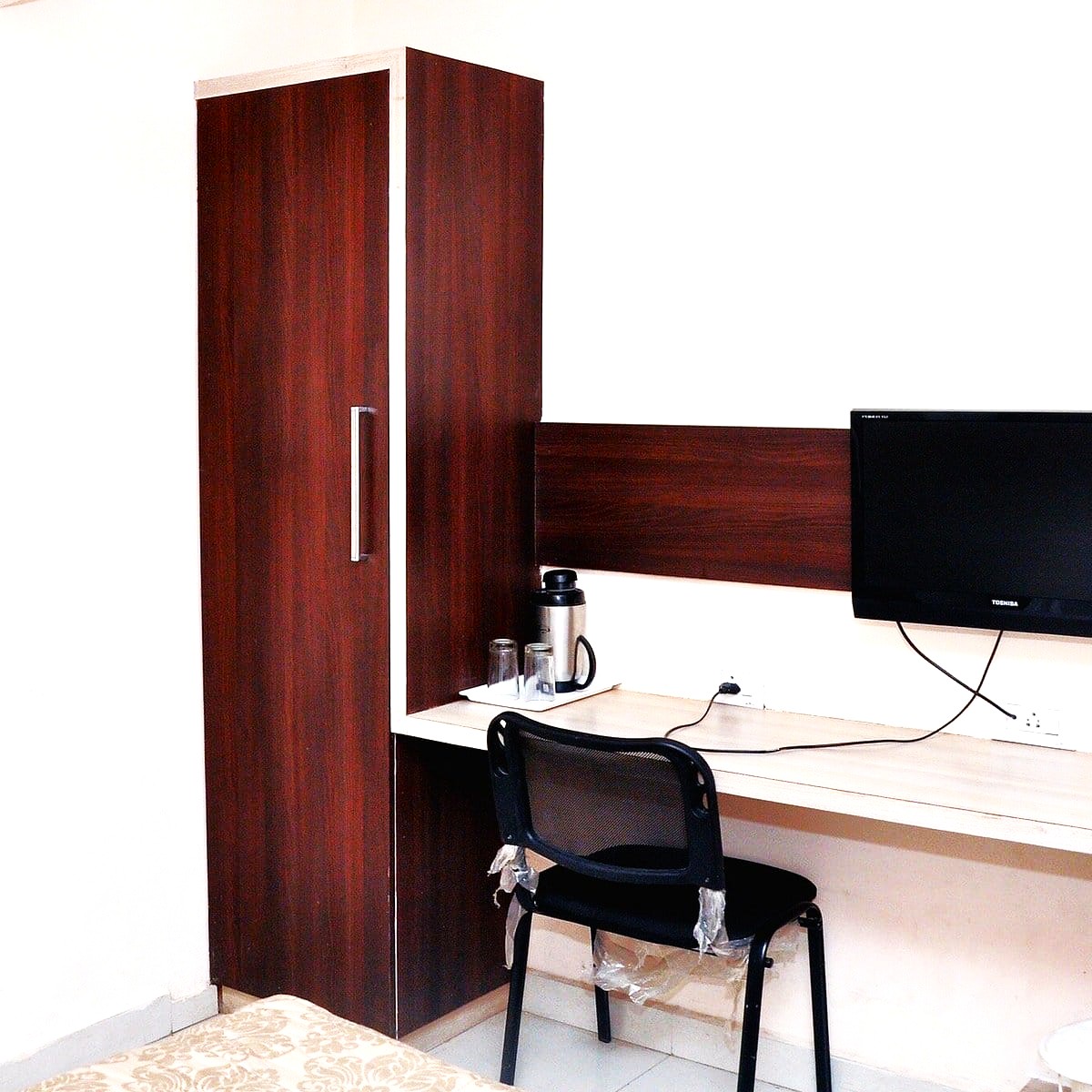 Modern double bed AC room with essential amenities at Shree Paras White Hotel Amreli